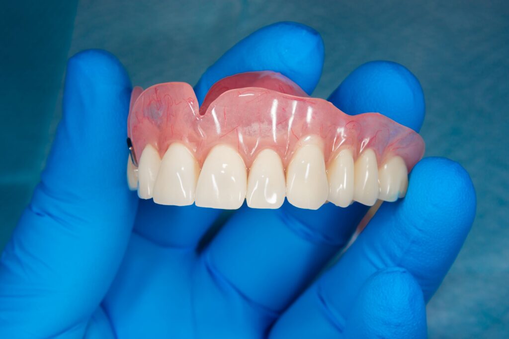 As shown here, removable dentures can be straighter and whiter than your natural teeth.